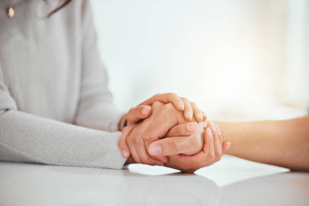 istock Shot of two unrecognizable people holding hands 1395082966