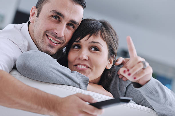 istock Relaxed young  couple watching tv at home 139509126