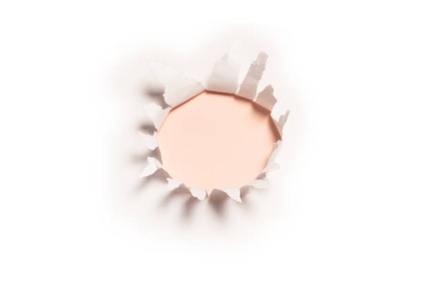 istock A hole in a white paper on a red background, copy space. 1395092249