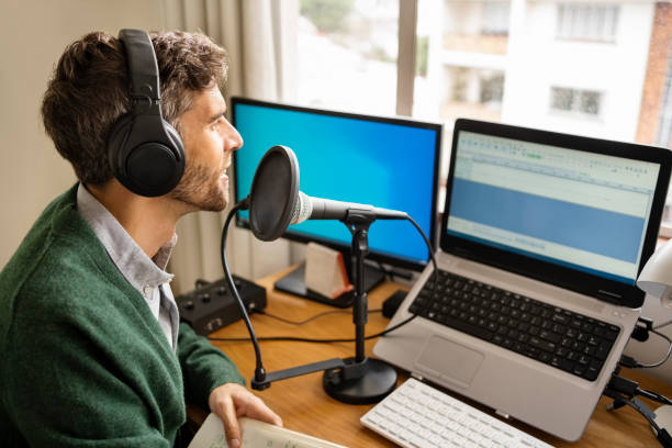 istock Man recording a podcast from his home studio 1395095199
