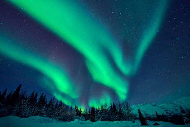 Green Aurora Borealis, Alaska, USA Beautiful green aurora borealis at midnight sky, Alaska, USA. aurora polaris stock pictures, royalty-free photos & images