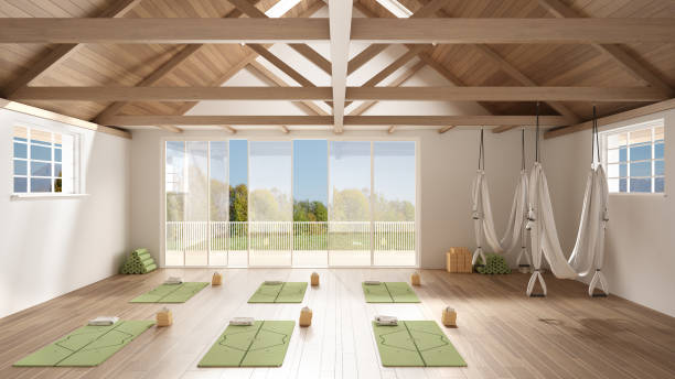 istock Empty yoga studio interior design, minimal open space with mats, hammocks and accessories, wooden floor and roof, ready for yoga practice, panoramic window with summer panorama 1395097003