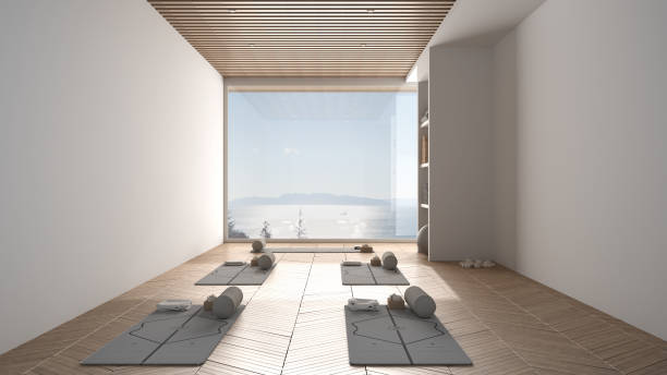 istock Empty yoga studio interior design, space with mats, pillows and accessories, parquet, wooden roof and big panoramic window with sea panorama, ready for yoga practice, meditation room 1395097026
