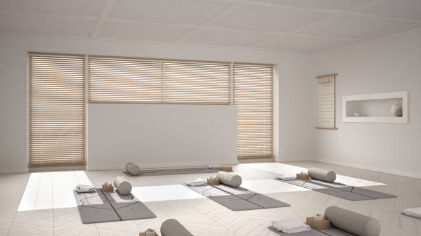 istock Empty yoga studio interior design, open space with mats, pillows and accessories, venetian bamboo blinds, herringbone parquet, big window, ready for yoga practice, meditation room 1395097540