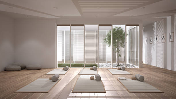 istock Empty yoga studio interior design, open space with mats, pillows and accessories, parquet, patio house, inner garden with tree and pebbles, ready for yoga practice, meditation room 1395097547