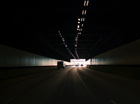 Motorway underground tunnel with sun shining through