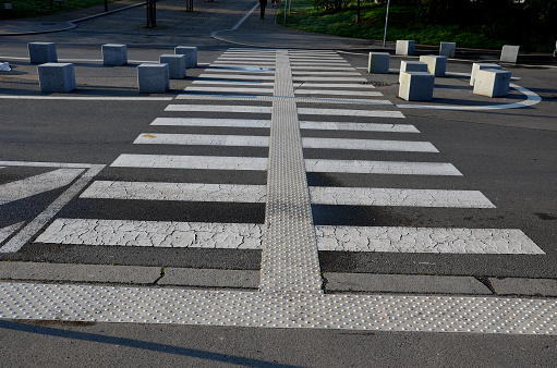 stone cubes barriers as protection of a nice lawn cube cubes on a paved sidewalk platform of a tram protected from the entry of cars