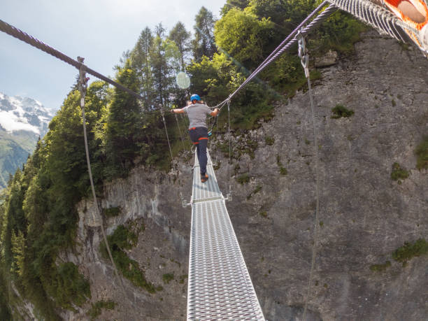 istock Two people on Via Ferrata climbing up, summer activities concept 1395098890