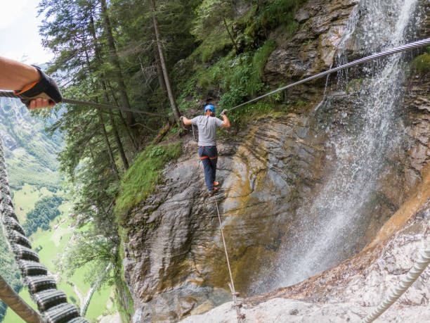 istock Two people on Via Ferrata climbing up, summer activities concept 1395099026