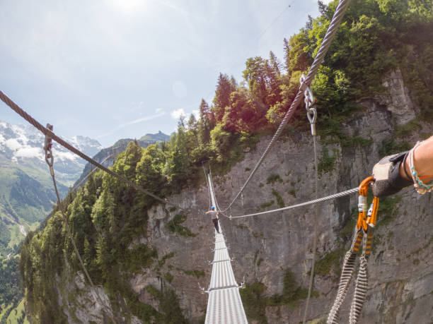 istock Two people on Via Ferrata climbing up, summer activities concept 1395099177
