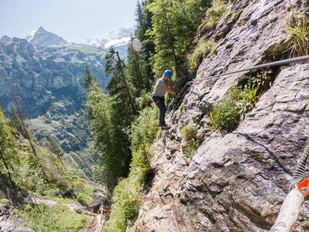 istock Two people on Via Ferrata climbing up, summer activities concept 1395099987