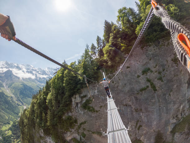 istock Two people on Via Ferrata climbing up, summer activities concept 1395100084
