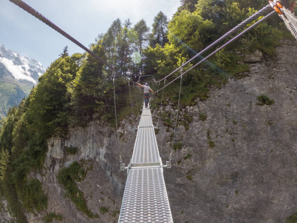 istock Two people on Via Ferrata climbing up, summer activities concept 1395100132