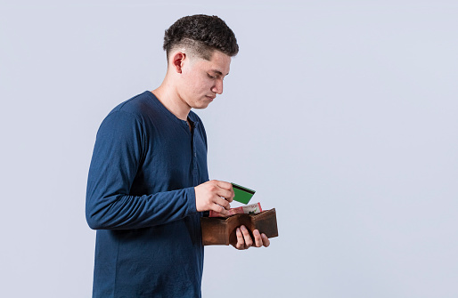 man taking out credit card from his wallet, a guy paying with credit card on isolated background , concept of man with credit card