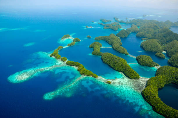 The Gorgeous “Garden on the Ocean” of Palau: Aerial View of Rock Islands Palau- October 6, 2015: Palau is a beautiful island in the Philippine Sea, Northern Pacific Ocean. It is well-known for its race scenery, the Rock Islands. When you take the airplane over the Islands, you can see stunning view of  reefs, jungles, beaches, lagoons and  turquoise color sea waters, no words can describe the beauty of the "Garden on the Ocean". pacific islands stock pictures, royalty-free photos & images