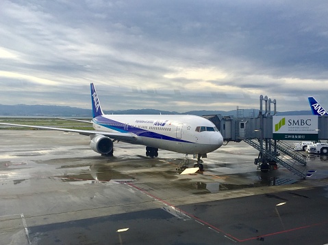 Osaka, Japan- October 2, 2015: Osaka Kansai Airport is one of the major airports in Japan. Here is a Boeing 767 aircraft of ANA stops at the airport.