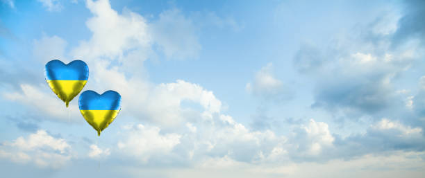 istock Sky clouds background with two balloons with Ukrainian flag. Love Ukraine concept 1395105268