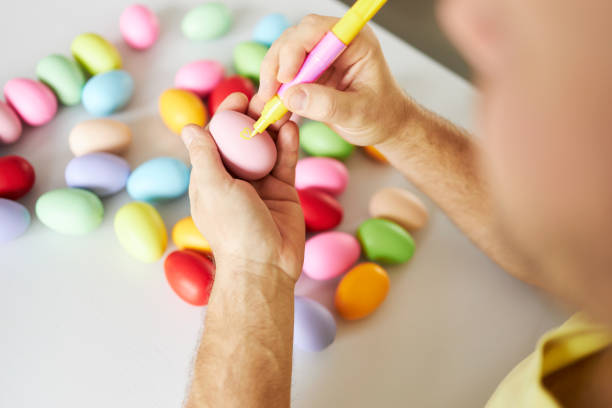 istock An Easter egg decorated and painted by male hands 1395108299