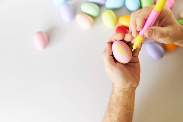istock An Easter egg decorated and painted by male hands 1395108359