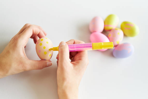 istock An Easter egg decorated and painted by female hands 1395108456