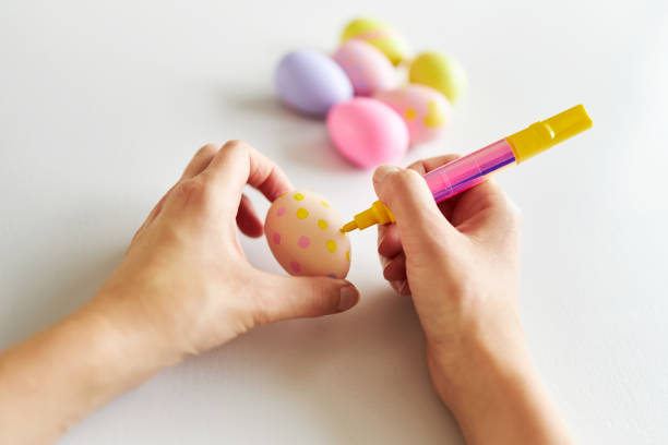istock An Easter egg decorated and painted by female hands 1395108494
