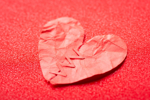istock Torn apart paper heart with red stitches 1395109263