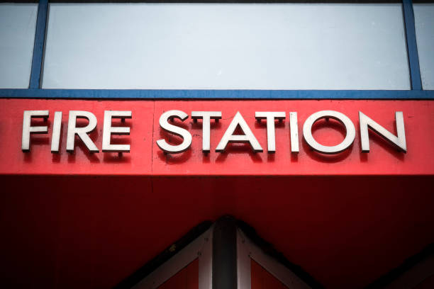 istock Fire station metal sign against bright red background 1395111796
