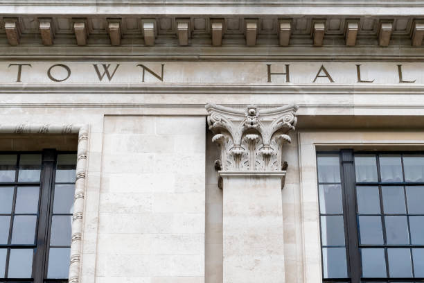 istock Town hall sign on white stone urban building 1395111811