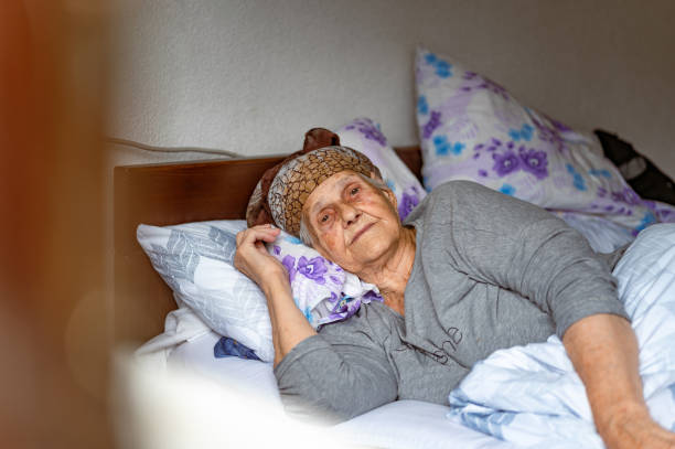 istock Old woman resting in a bed 1395113752