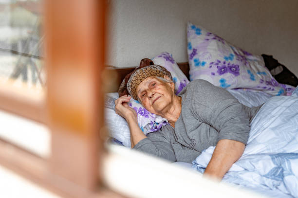 istock Old woman resting in a bed 1395113753