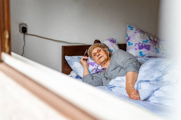 istock Old woman resting in a bed 1395113763