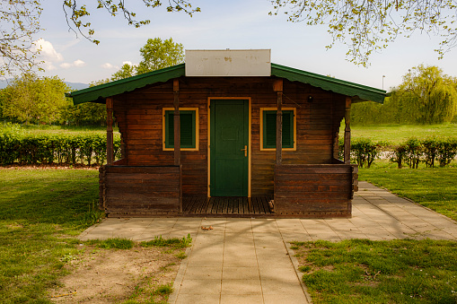 small wooden house in a public park, late spring