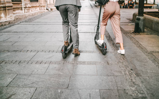 istock Two business people pushing electric scooter 1395114585