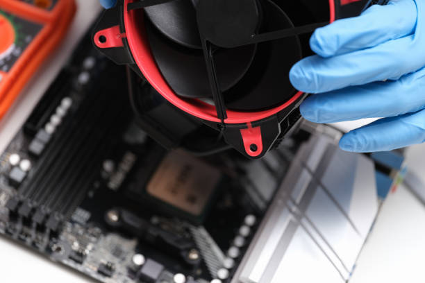 istock Man in white gloves installing laptop fan 1395114724