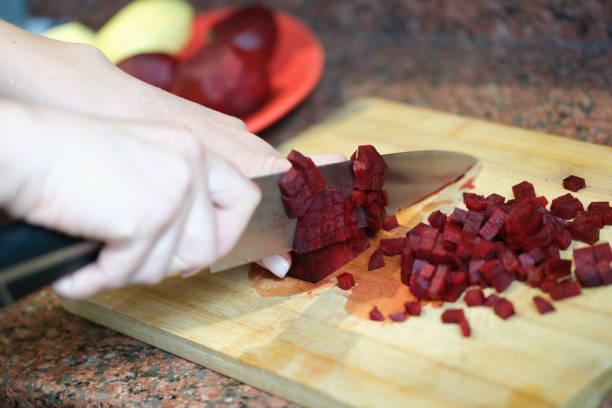 Cutting Fresh Parsnips on Wooden Board