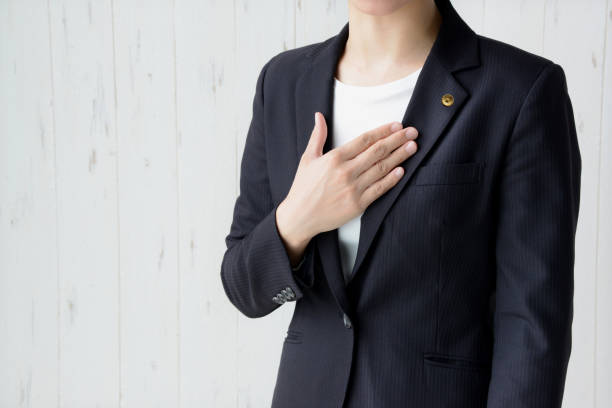 japanese female lawyer with hand on chest - lawyer young adult suit expressing positivity imagens e fotografias de stock