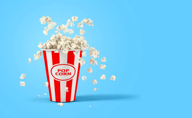 istock Falling popcorn in box isolated on a blue background with copy space 1395116348