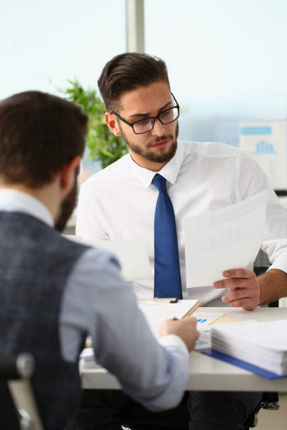 istock Coworkers men working at financial papers, solve and discuss problems 1395116402