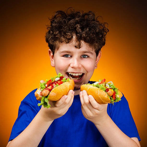 istock Boy eating hot dog 139511660