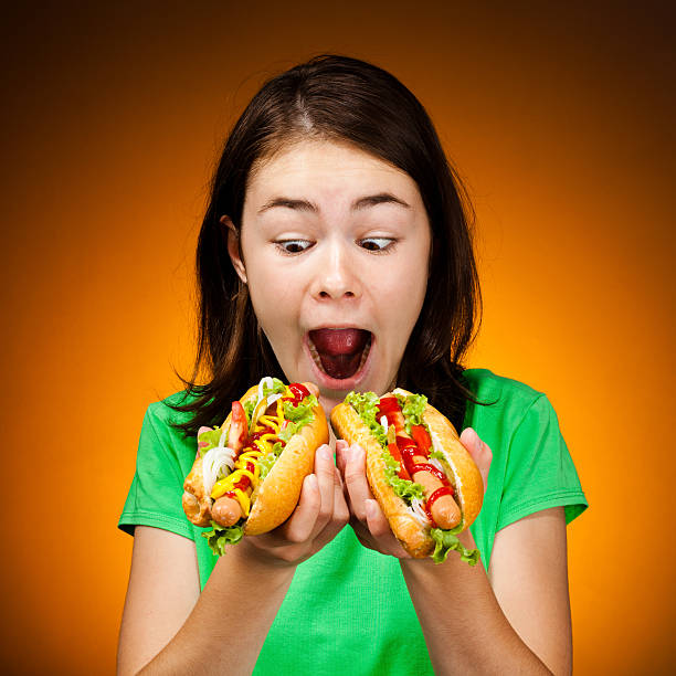istock Girl eating hot dog 139511693
