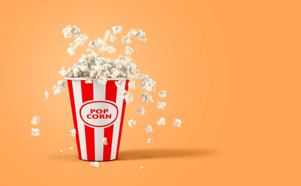 istock Falling popcorn in box isolated on a orange background with copy space 1395117004