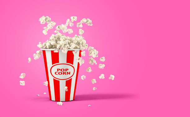 istock Falling popcorn in box isolated on a pink background with copy space 1395117005