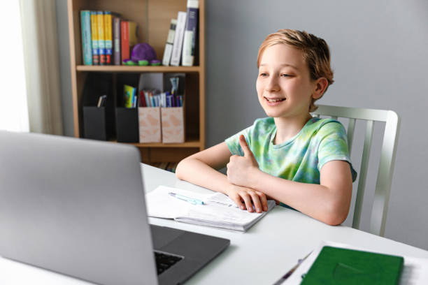 istock Homeschooling. Kid boy studying with video online lesson at home 1395117117