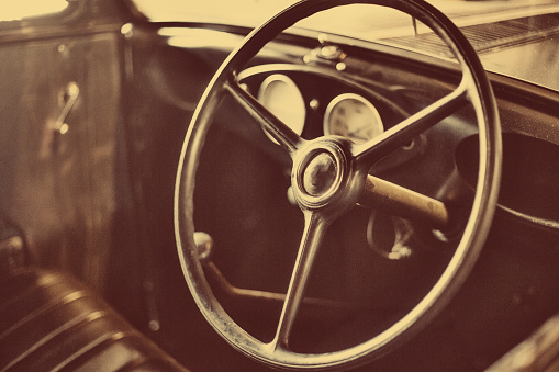 Old car interior with steering wheel