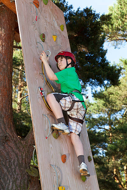 istock Boy climbing in adventure park 139512089