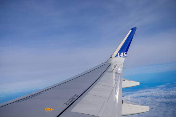 Wing of a Airbus 320NEO plane from SAS against the blue sky over Denmark