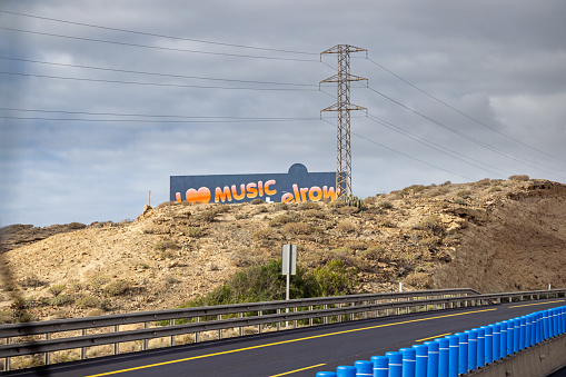 Billboard advertisement poster beside the north south highway on the Spanish Canary island Tenerife. The high way connects the main city Santa Cruz in the north with the airport and the tourist areas in the south of the island