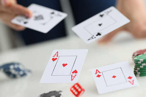 Close-up of playing cards for poker game, gamble games and casino. Profession player throwing trump out of sleeve. Strategy and business card game concept