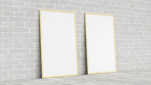 Mock up of two vertical woodenframes on the floor with white brick wall. 3d render