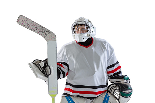 Concentration. Portrait of boy, child, hockey player in uniform of goalkeeper posing isolated over white studio backgrund. Concept of sportive lifestyle, childhood, hobby, action. Copy space for ad